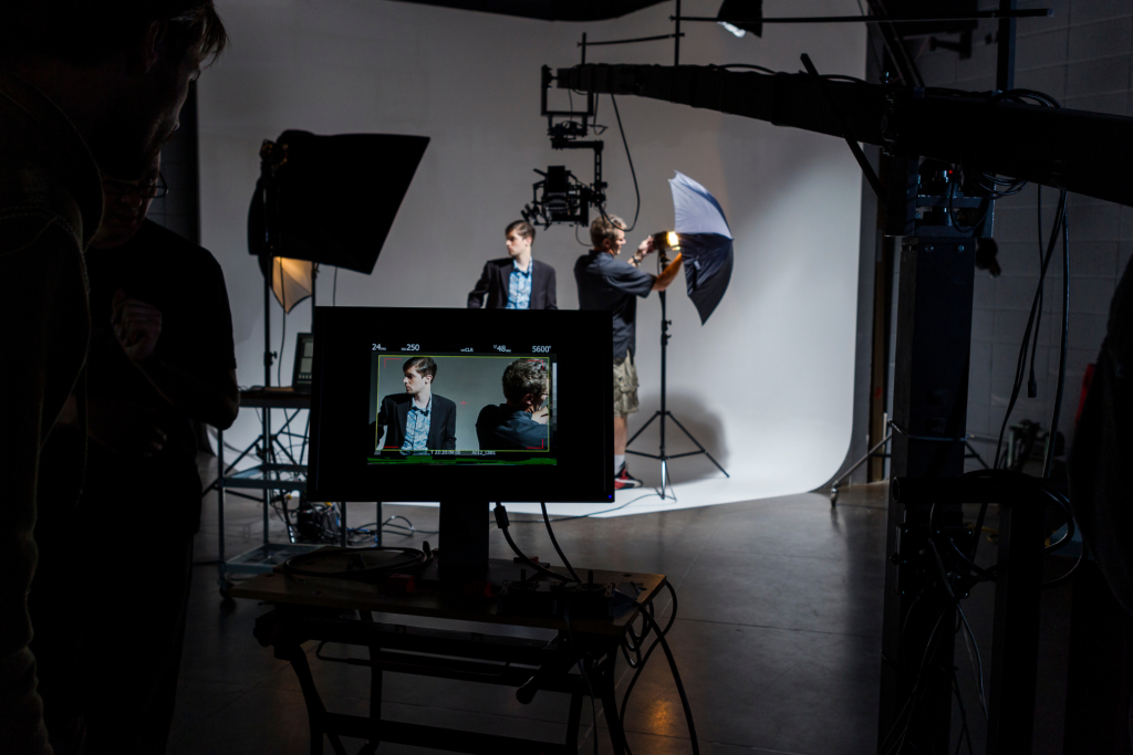 Film crew preparing a studio shoot, illustrating early-season production insurance needs for equipment and talent